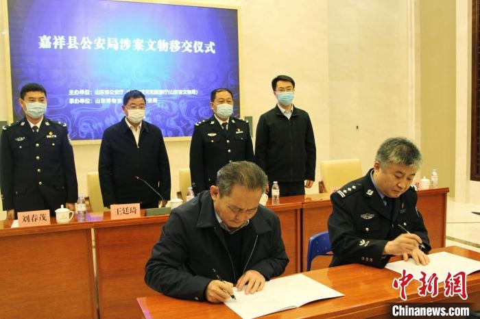 山東博物館館長(zhǎng)鄭同修和嘉祥縣人民政府副縣長(zhǎng)、公安局局長(zhǎng)趙健簽署移交協(xié)議?！≮w曉 攝