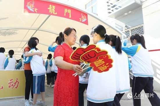 6月7日一早，雄安新區(qū)安新中學(xué)老師在給同學(xué)們加油鼓勁兒。人民網(wǎng) 李兆民攝