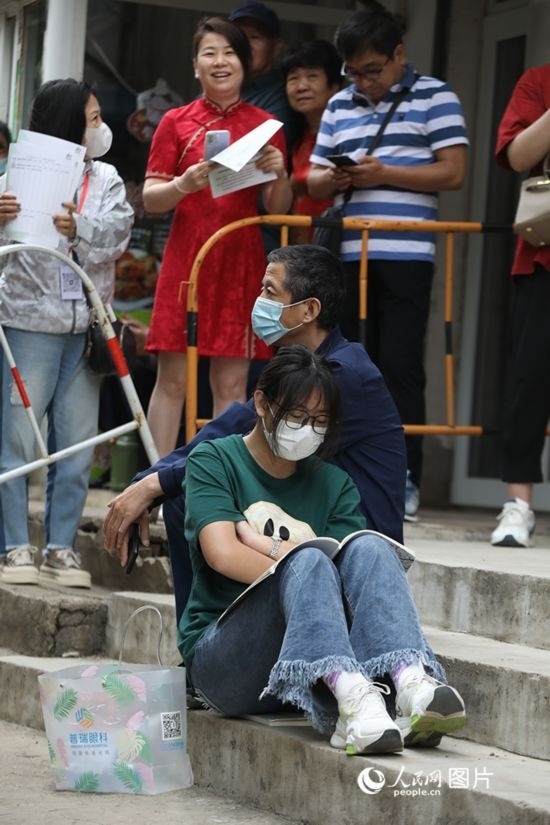6月7日，沈陽(yáng)市第一中學(xué)，學(xué)子靠在父親身邊做最后的沖刺。人民網(wǎng) 周頌雪攝