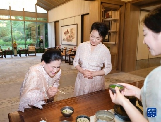 7月27日下午，國(guó)家主席習(xí)近平夫人彭麗媛在四川成都會(huì)見陪同印度尼西亞總統(tǒng)佐科來華出席第31屆世界大學(xué)生夏季運(yùn)動(dòng)會(huì)開幕式并訪華的總統(tǒng)夫人伊莉亞娜。這是彭麗媛邀請(qǐng)伊莉亞娜觀看茶藝表演，并同伊莉亞娜親切茶敘。新華社記者 丁林 攝