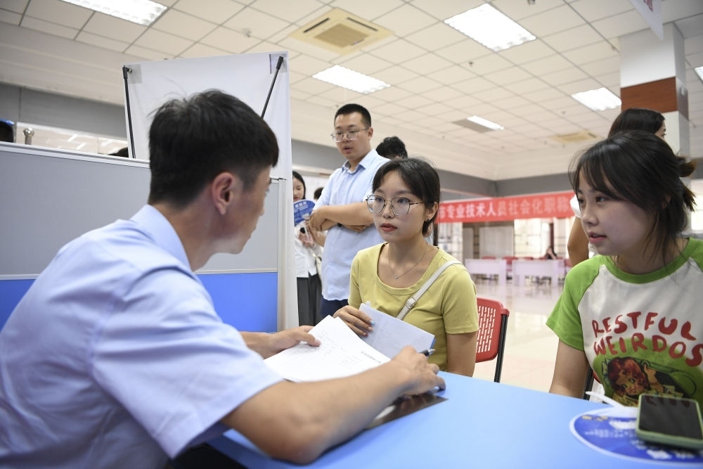 2023年7月29日，“揚(yáng)就業(yè)之帆，啟夢(mèng)想之旅”2023年寧夏（銀川）離校未就業(yè)高校畢業(yè)生招聘會(huì)在寧夏（銀川）人力資源服務(wù)產(chǎn)業(yè)園舉行。求職者（右）在招聘會(huì)現(xiàn)場(chǎng)與用人單位交流。新華社記者 馮開華 攝