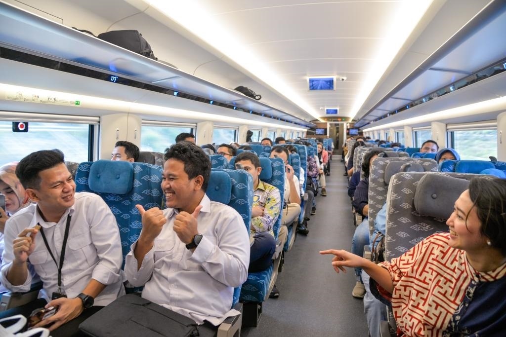 10月17日，乘客在行駛中的雅萬高鐵高速動(dòng)車組列車車廂內(nèi)交談。