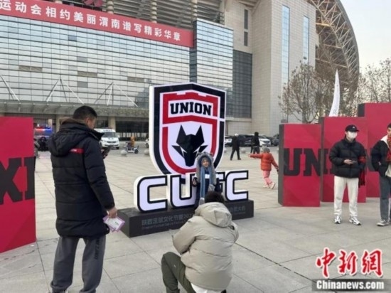 球迷們與隊(duì)徽合影。記者 卞立群 攝