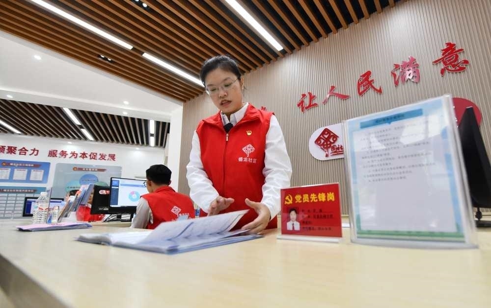 △2023年12月14日，廣西南寧市蟠龍社區(qū)，工作人員在為居民服務(wù)。