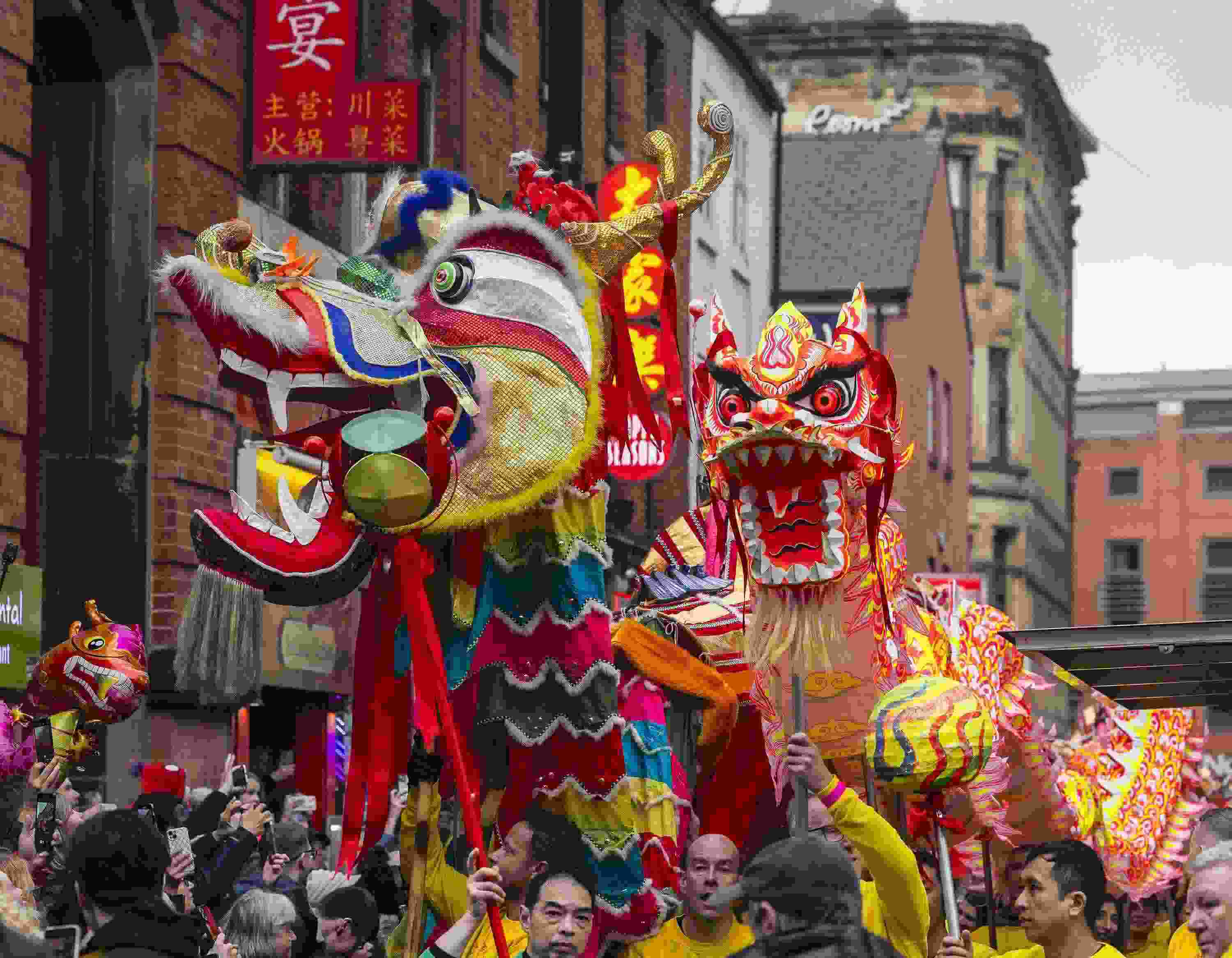 △ 當(dāng)?shù)貢r(shí)間2024年2月11日，英國(guó)曼徹斯特，表演者進(jìn)入中國(guó)城，參加中國(guó)農(nóng)歷龍年春節(jié)的慶祝活動(dòng)。