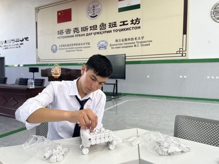 在塔吉克斯坦魯班工坊內(nèi)，學(xué)員正在操作能力源創(chuàng)新套件。本報(bào)記者 屈佩 攝