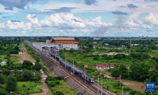 8月5日，由老撾籍火車司機(jī)獨(dú)立駕駛的滿載貨物的列車駛出萬象站，向中國昆明進(jìn)發(fā)（無人機(jī)照片）。新華社發(fā)（楊永全 攝）