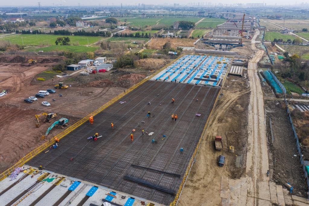3月7日，在524國道秀洲王江涇至新塍公路工程TJ02標(biāo)段，作業(yè)人員正在進(jìn)行60米鋼混組合梁現(xiàn)澆橋面板鋼筋焊接及綁扎作業(yè)（無人機(jī)照片）。新華社記者 徐昱 攝